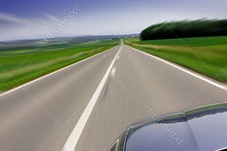 Fast moving car on road