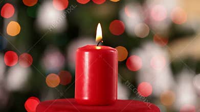 Christmas candle spin and slide in front of blurry lights