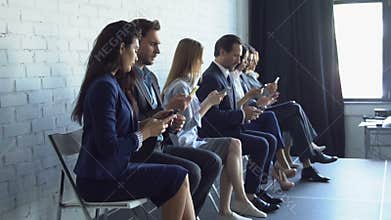 Group Of Business People Using Cell Smart Phones Typing Messages On Modern Gadgets Businesspeople Sitting In Row