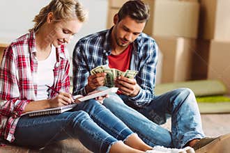 Young couple counting money