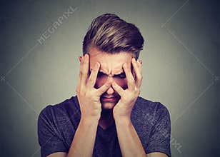 Sad young man looking down. Depression and anxiety disorder concept