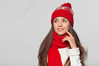 Beautiful woman thinking looking to the side at blank copy space. Winter concept smile girl wearing knitted warm hat and scarf