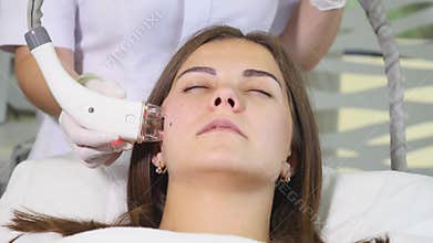 Woman getting rf-lifting in a beauty salon. Woman having a stimulating facial treatment. Skin care face. Skin treatment