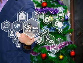 The businessman chooses EMAIL MARKETING on the touch screen, the