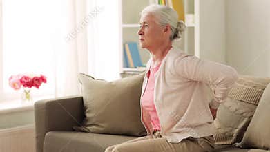 Senior woman suffering from pain in back at home
