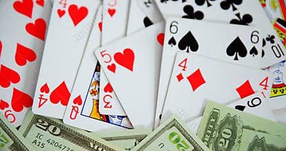 Playing cards and us dollar on poker table 4k