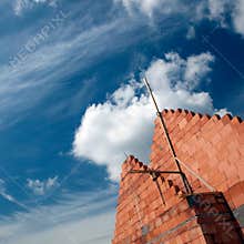 Brick building and cloudscape