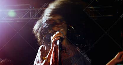 Singer performing on stage at a concert 4k