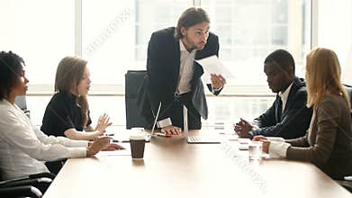 Angry boss scolding employee for bad work result at meeting