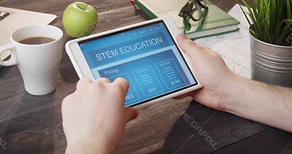 Browsing STEM education app using portable computer at desk