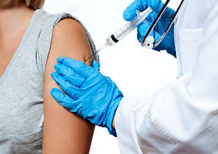 Vaccination. Doctor injecting flu vaccine to patient`s arm.