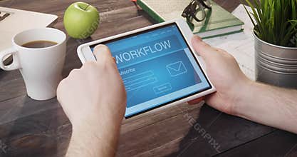 Looking at workflow info using digital tablet at desk