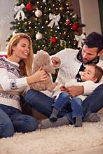 Happy Christmas family playing with bear