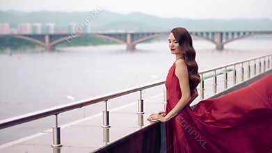 Beautiful woman in red fluttering dress.