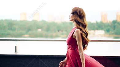 Beautiful woman in red fluttering dress.