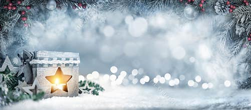 Christmas background with lantern, fir branches and bokeh lights