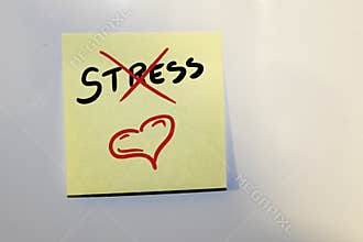 Post-it note with the text stress covered by a cross.