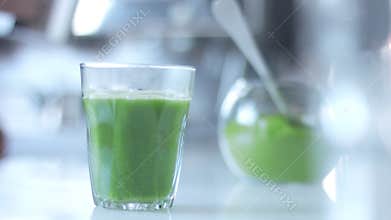 Matcha tea preparation in cafe by mixed race barman