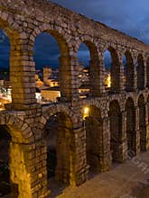 Segovia, Spain at the ancient Roman aqueduct. The Aqueduct of Segovia, located in Plaza del Azoguejo, is the defining historical f