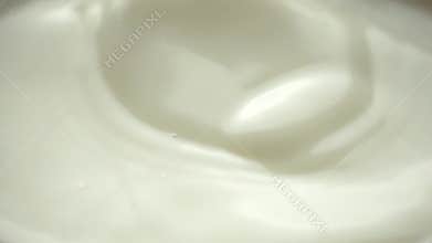 Almond falling in the milk closeup - slow motion