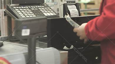 Cashier gives the change in the supermarket