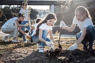 Cute pretty girls planting trees