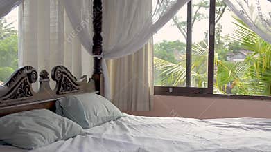 Beautiful bedroom with a four poster bed in a luxury private holiday villa rental in rainforest in Asia. Bali, Sri Lanka
