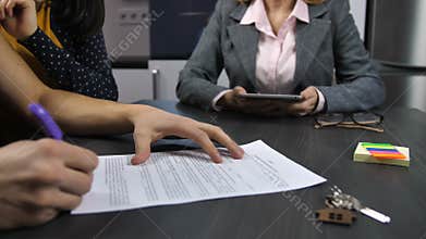Husband`s hands signing mortgage contract