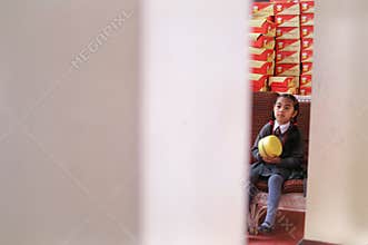 DARJEELING INDIA - APRIL 2012 : Girl sitting on sofa at bakery shop in Darjeeling, India as of April 12, 2012