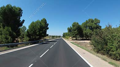 Motorcyclist Rides on a Beautiful Landscape Desert Scenic and Empty Road in Spain. First-person view