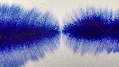 Beautiful watercolor blue ink drops on white paper. Artists paint with a brush, write a line on paper