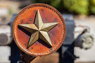 Antique leather ornament decorated with metal Texas star