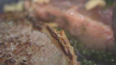 Closeup of delicious beef steaks placed on hot grill