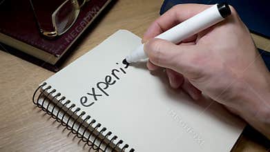 Man writing experience at note. Knowledge and wisdom.