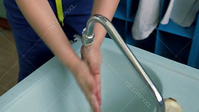 Baby hands under running water