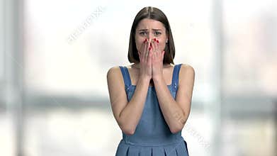 Young desperate woman on blurred background.