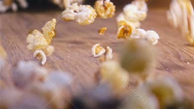 Popcorn falling on authentic wooden table - super slow motion shot
