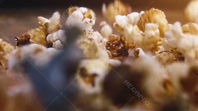 Popcorn falling on authentic wooden table - super slow motion shot