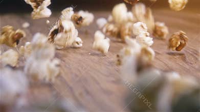 Popcorn falling on authentic wooden table - super slow motion shot