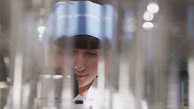 Lab Assistant Looks at New Sample with Microscope