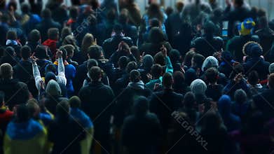 Rude football fans raising hands, screaming in support of team at sports stadium