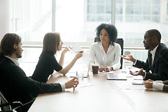 Diverse business partners arguing about bad contract at group me