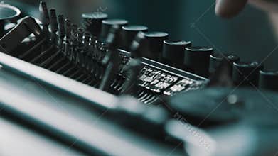 Writer typing with retro writing machine.