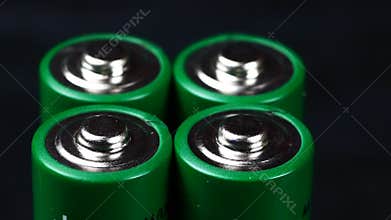 Batteries in extreme close up UHD stock footage. A collection of AA batteries in true macro close up with a sliding