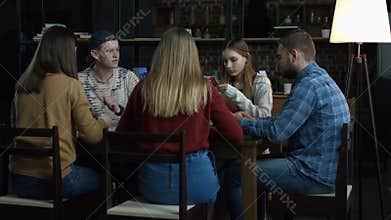 Teenagers having fun while playing board game