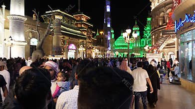 Dubai, UAE - January 12, 2018: tourists people resting on night entertainment park Global Village in Dubai city