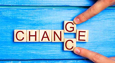 Wooden cube with word `change` to `chance` on wood table. Personal development and career growth or change yourself concept. conce