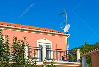 House with TV antenna on a roof.