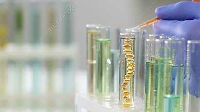 Cosmetology center worker adding essential oil to create concentrate agent