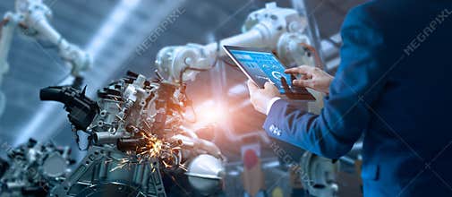 Manager engineer controlling automation robot arms machine